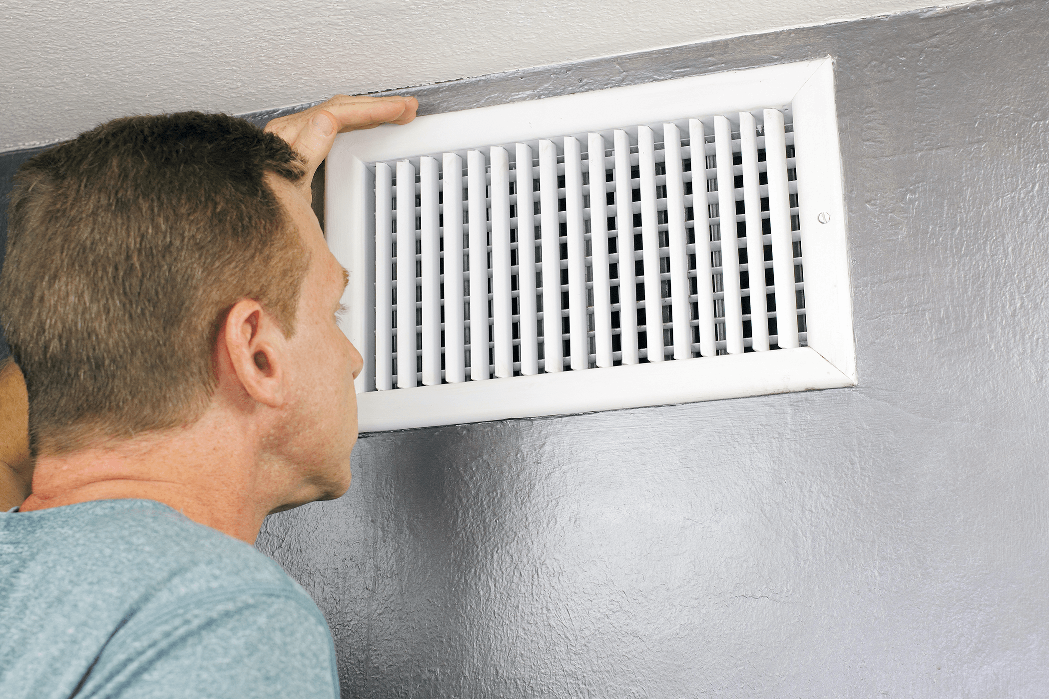 Custom Klimate Control Inc man checking vents